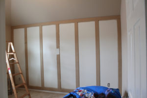 Vertical boards on paneled wall